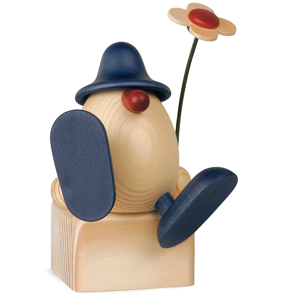 Eierkopf Alfons mit Blume auf Kante sitzend/tanzend, blau (ohne Klotz)